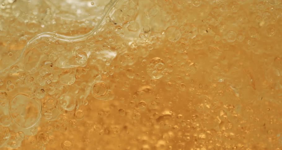 Oil with series of bubbles flowing aggressively