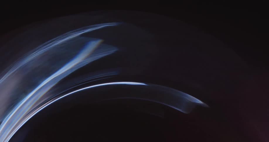 Abstract colored lights spinning in circular motion on a black background