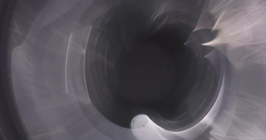 A metal wheel surrounded by light turns at a very fast speed