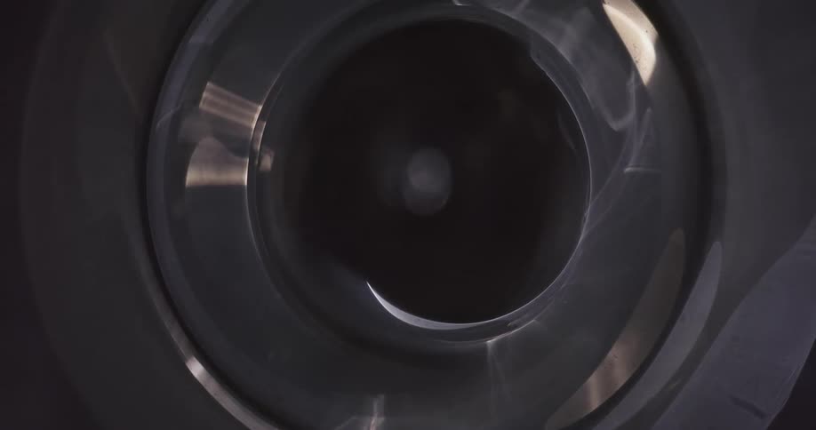 Light shines on a tunnel as it rotates and moves in the darkness