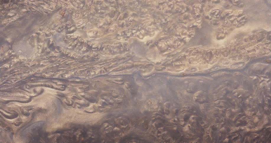 An abstract of gold fluid flowing and shifting