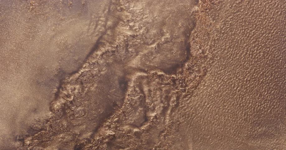 A brown texture with several small bubbles vibrating