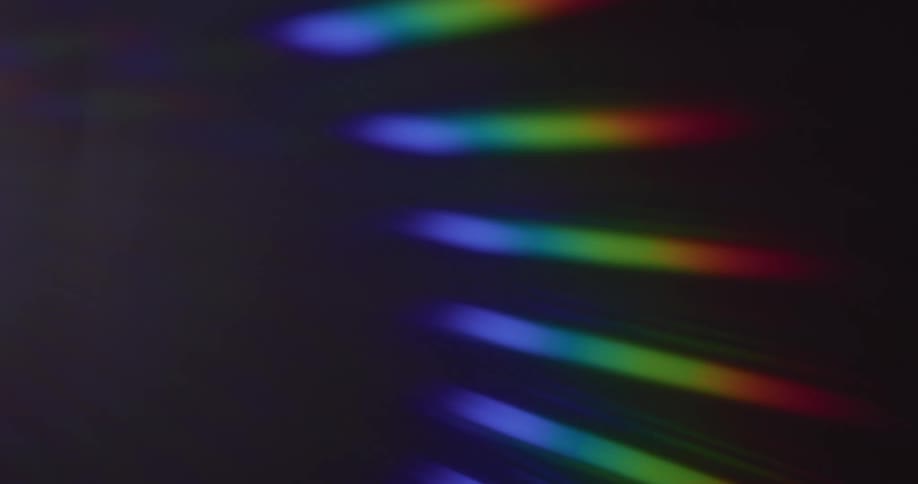 A row of fanned out rainbow lights moves from right to left