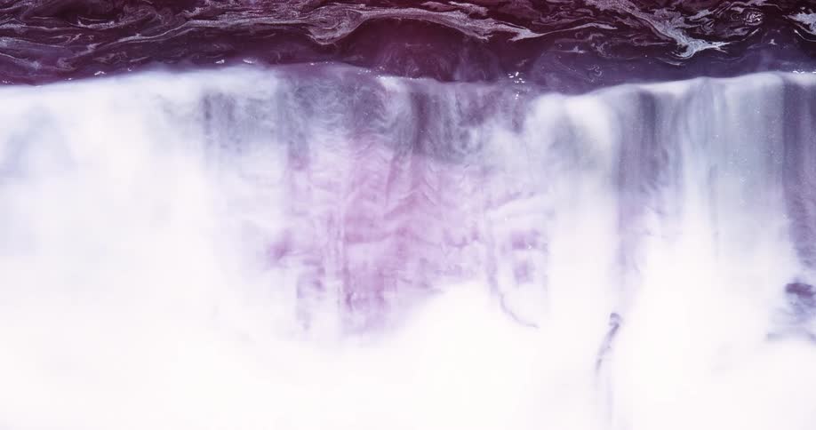 Abstract dense liquid with purple and white colors in a tidelike motion