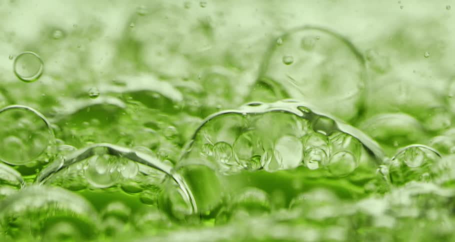 Green liquid with abstract bubbles in motion