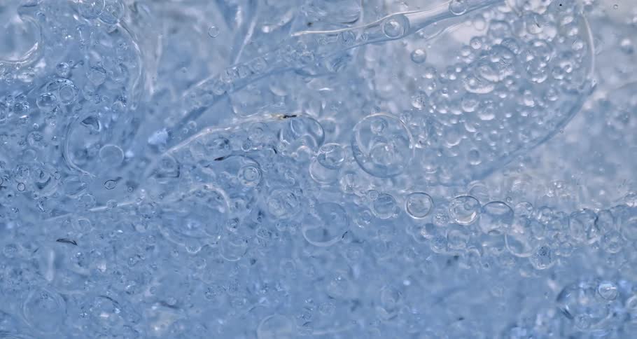 Air bubbles slowly move through a thick blue liquid