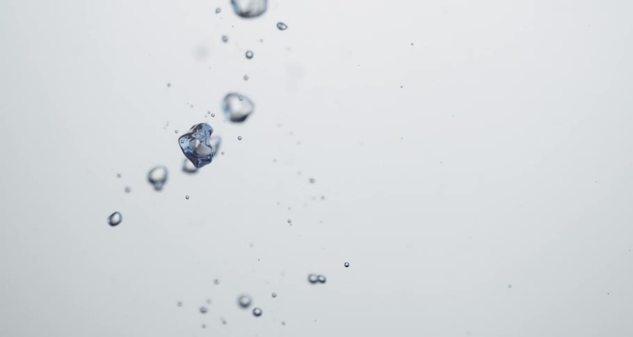 Air bubbles rise up through clear water