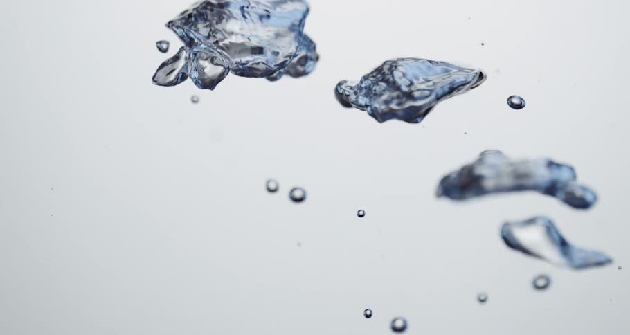Large irregularly shaped bubbles shimmer with blue as they rise through fluid