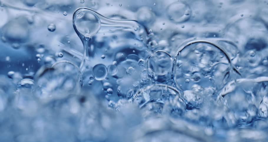 Air bubbles slowly move through a thick blue liquid