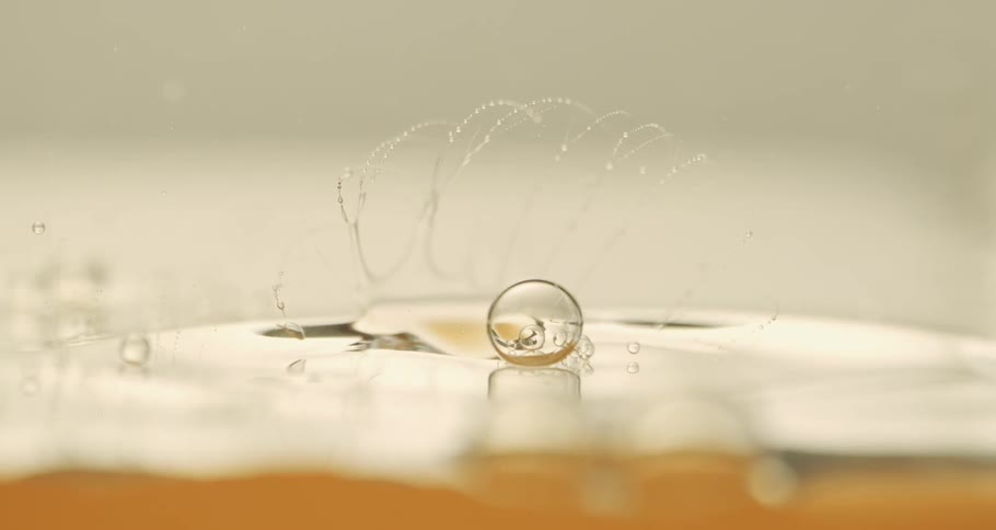 Abstract water bubble bursting in slow motion