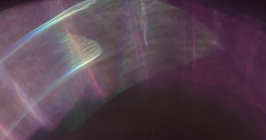 Arched reflection of light flares against a black background