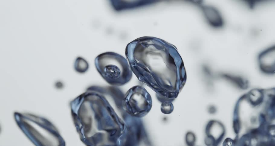 Bubbles of various sizes and shapes with blue surfaces rise through clear liquid