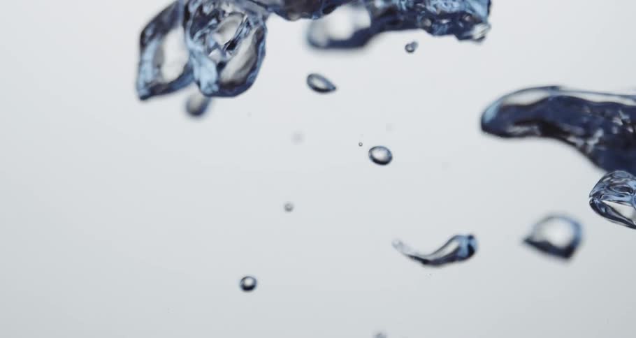 Clear water droplets moving upward slowly against a white background