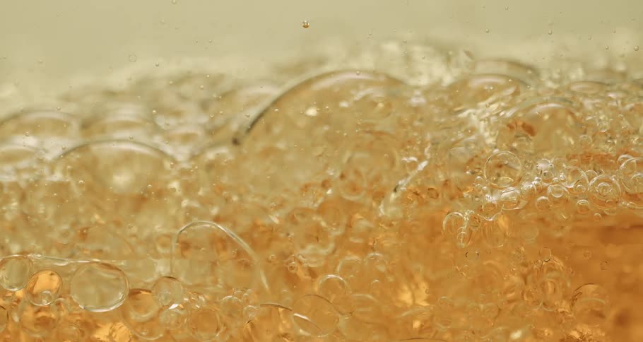 Clear soapy liquid moving slowly and swirling around