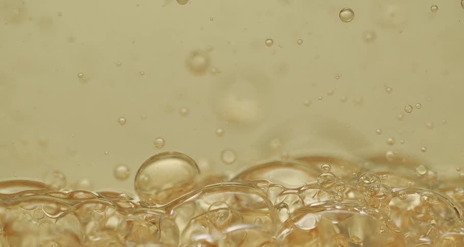 Bubbles in gold color flowing upward