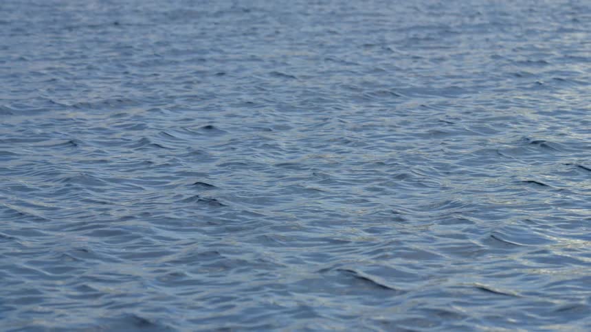 The water is rough below on a sunny day