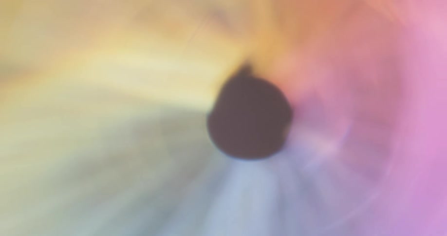 A black light being dominated by round colored lights