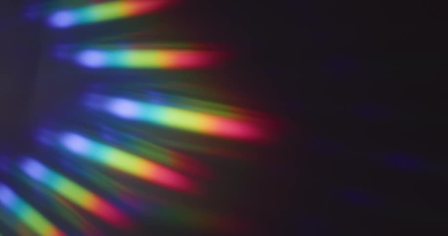 Rays of rainbow colors on a black canvas as the colors fade out