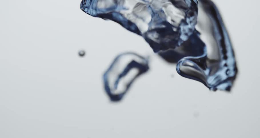 A clear water droplet slowly moving upward against a white canvas background