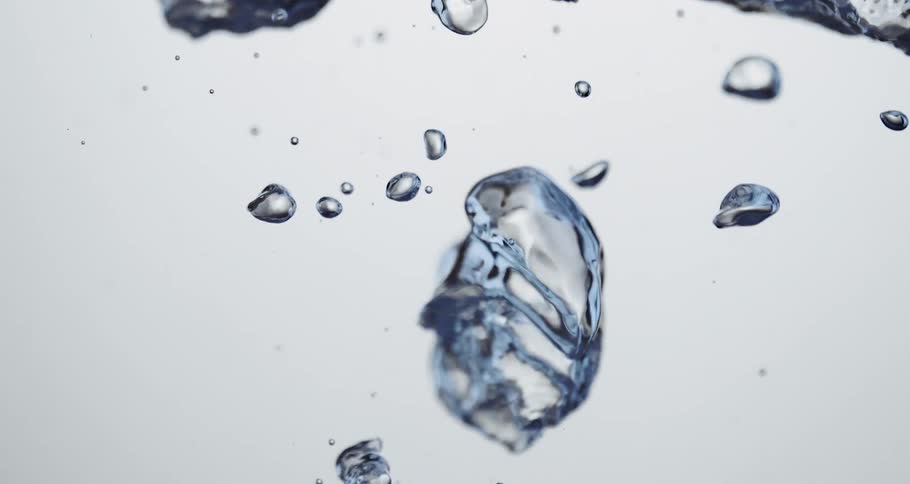 Water droplets slowly moving upward against a white canvas background