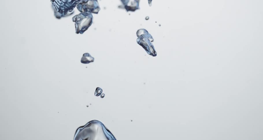 Rippling air bubbles rise on clear water