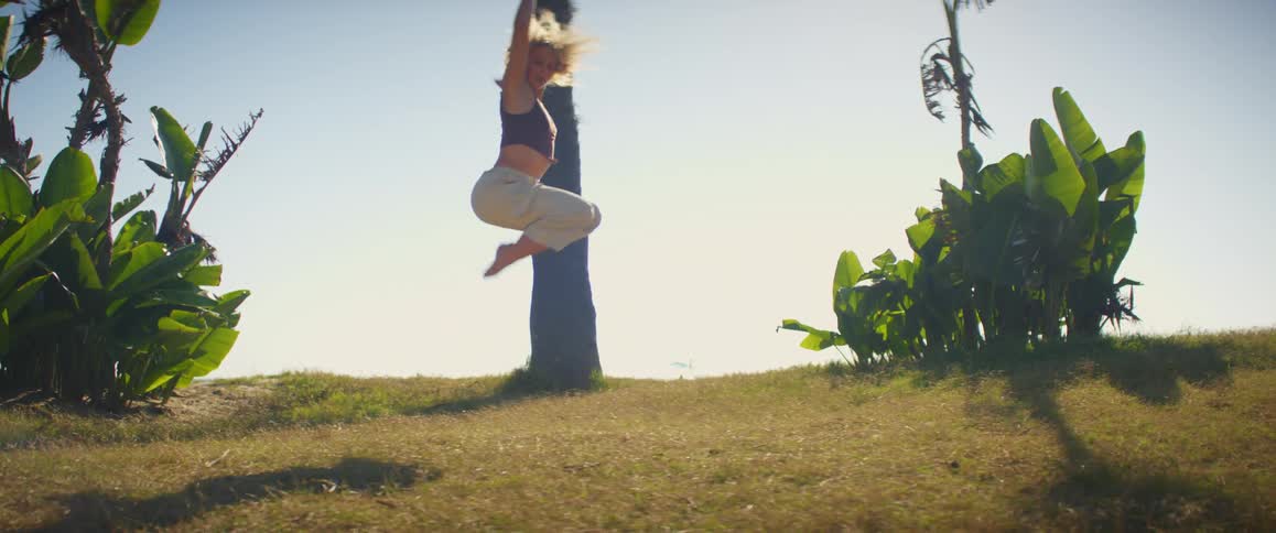 A woman is dancing on the hill