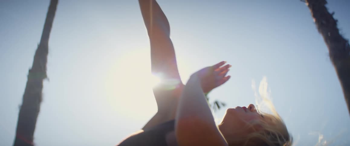 A woman dancing outdoors during the sunny morning