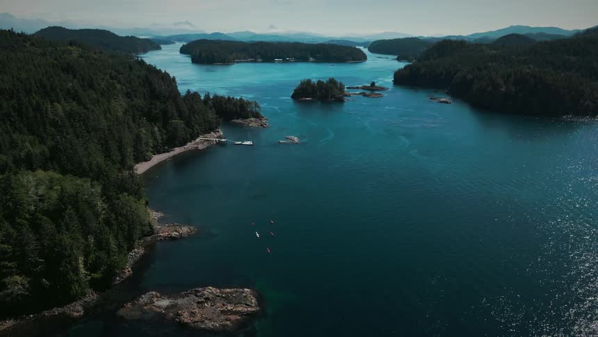 Landscape of a turquoise blue sea surrounded by peninsulas with coniferous trees