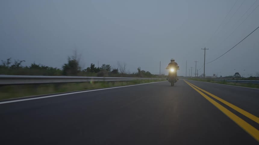 Motorcycle riding on the road in the late afternoon