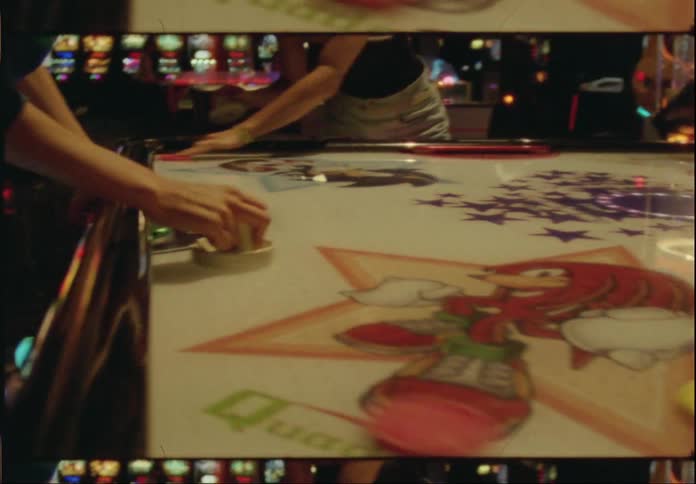 Friends playing arcade games in an indoor environment