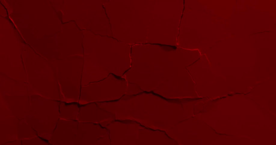 Abstract red wall with cracks forming