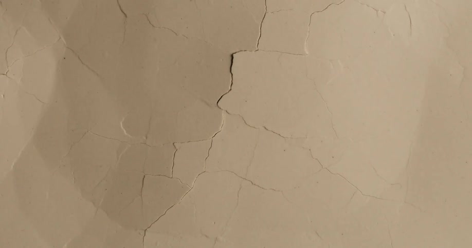Movement breaks and cracks a smooth brown surface