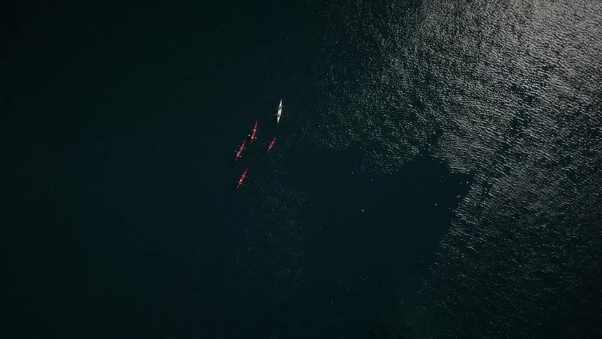 Red and white kayaks floating on a lake