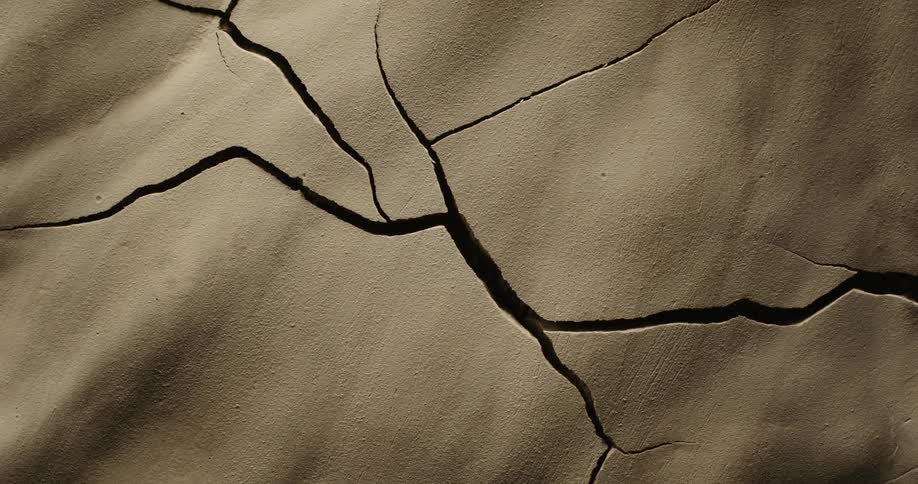Cracks form then spread and increase in size through drying ground
