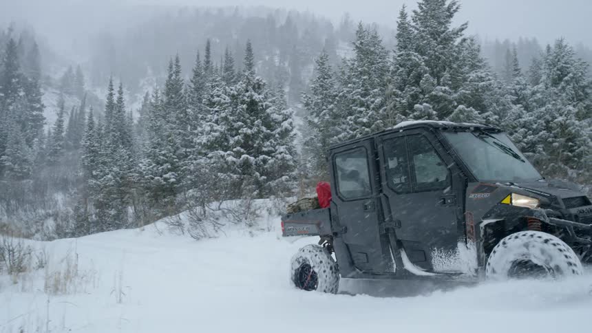 A vehicle is driving in heavy snow