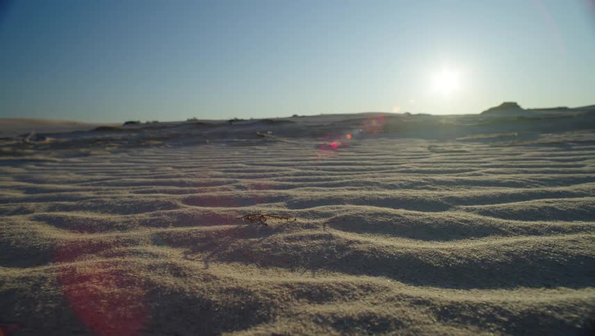 The sun shines over the sand in the desert