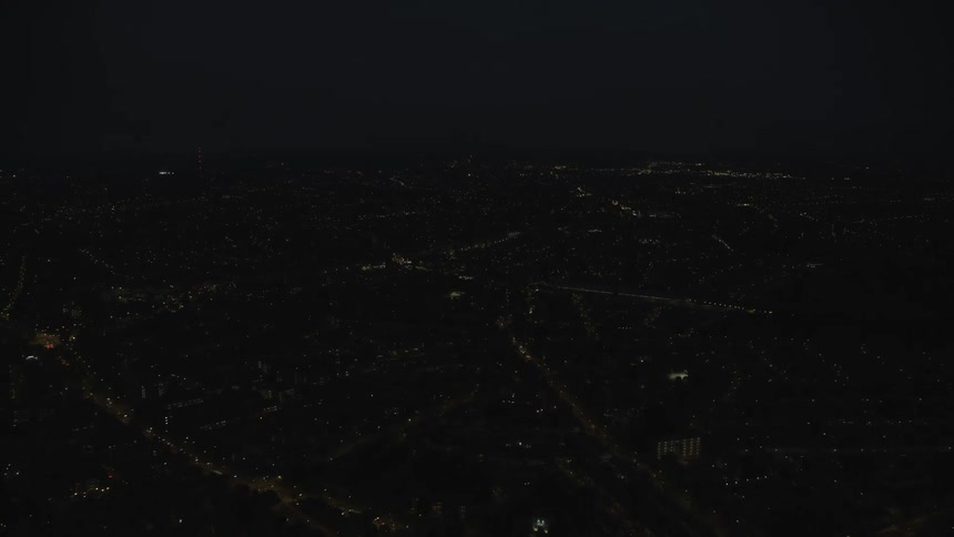 Aerial view of lit buildings and highways city at night