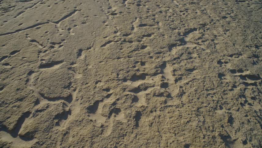 Aerial view moving over dry rough terrain