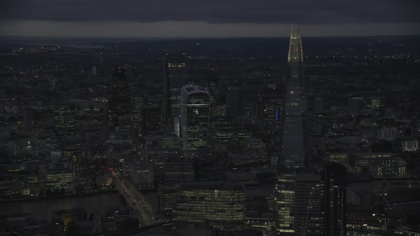 Aerial view of illuminated skyscrapers and high rise buildings in the city at night