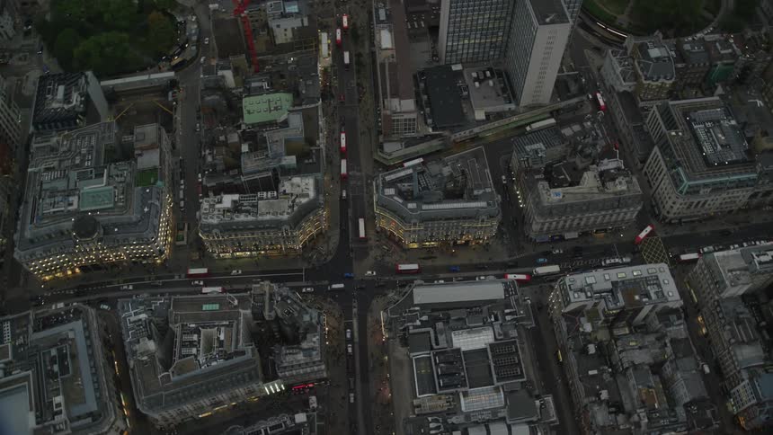 Traffic moves through downtown with buildings and towers close together on the city blocks
