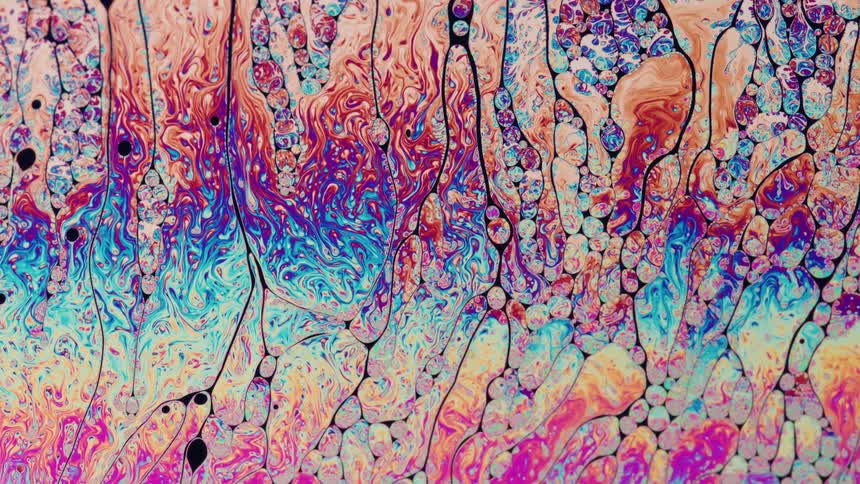 Various colors of a liquid randomly forming some circular shapes