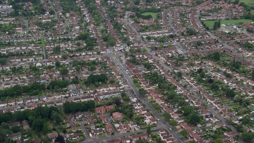 Traffic passes along roads through residential neighborhood