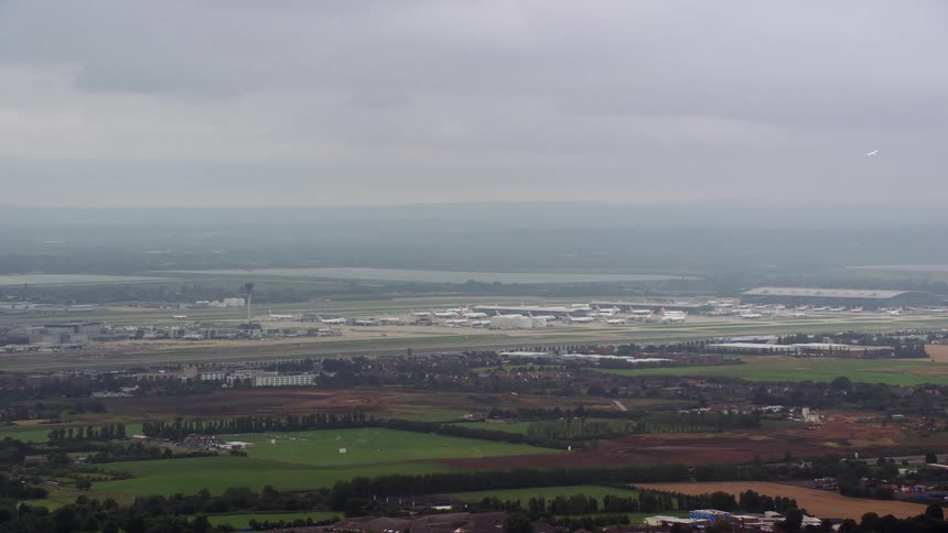 Aerial view of a rural area and an airport with planes landing and others taking off