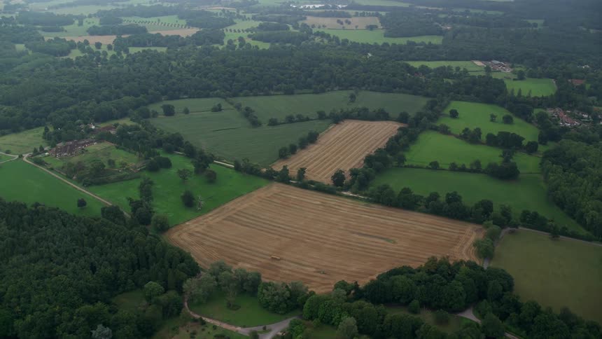 Aerial view of a rural area with large field with grassland