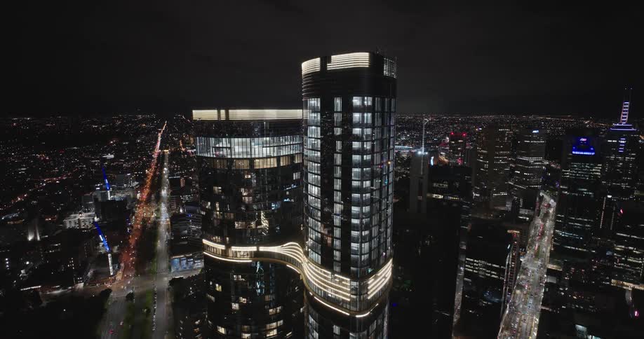 View of a mirrored skyscraper at night in a metropolis