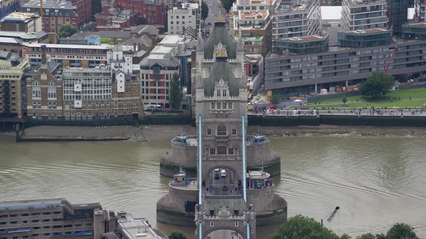 A historical looking city is shown from above with a bridge going over a river