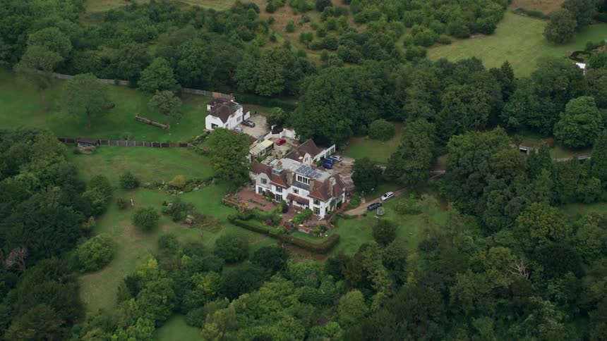 Fields and woods surround mansion isolating it from busy roadway