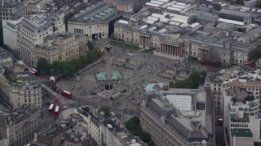Traffic moves along london streets near busy trafalgar square