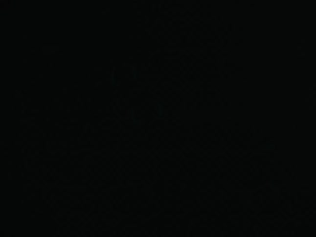 An object with some bubbles inside being illuminated by a light source and then left in the dark