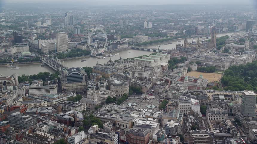 An aerial view of a city with a river in the middle and a ferris wheel